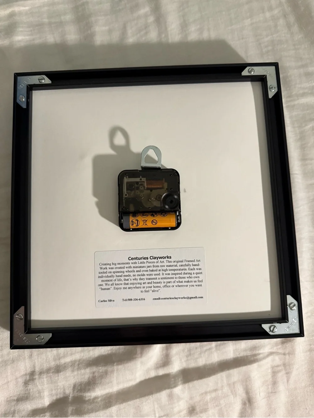This 10x10 inch shadowbox wall clock, signed by artist Carlos Silva of Centuries